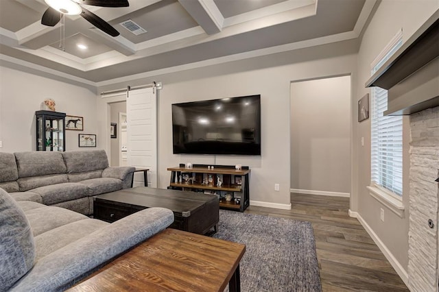 living room with beamed ceiling, coffered ceiling, ceiling fan, a barn door, and dark wood-type flooring