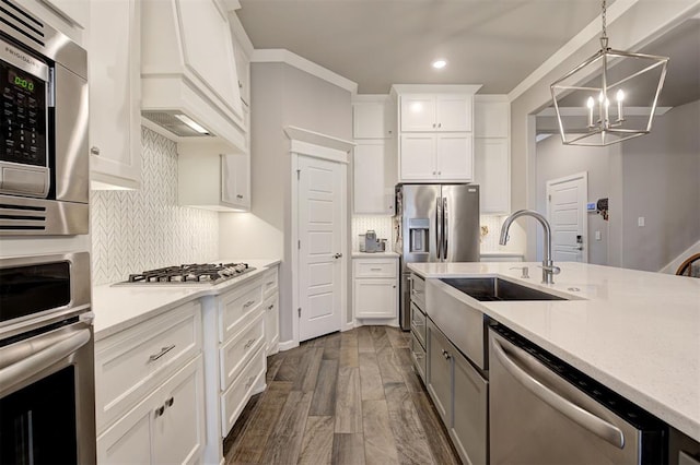 kitchen featuring sink, dark wood-type flooring, white cabinetry, hanging light fixtures, and stainless steel appliances