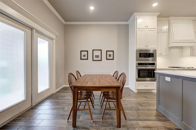 dining space with crown molding and dark hardwood / wood-style flooring