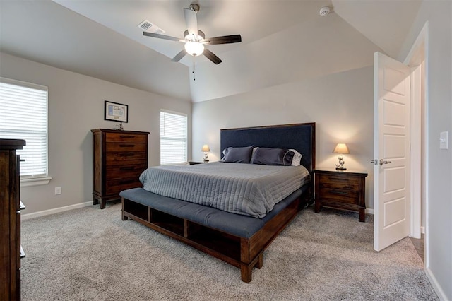 bedroom with multiple windows, vaulted ceiling, light colored carpet, and ceiling fan