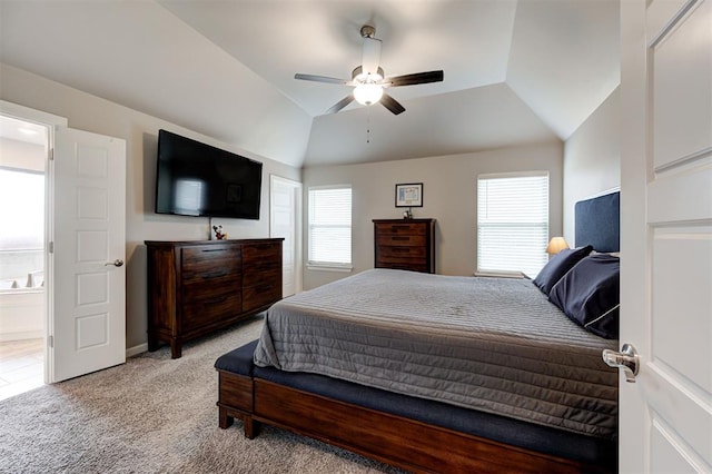 bedroom featuring multiple windows, lofted ceiling, light colored carpet, and ceiling fan