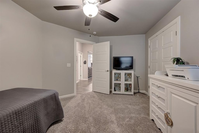 bedroom with ceiling fan and light carpet