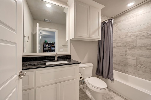 full bathroom featuring vanity, shower / tub combo, and toilet