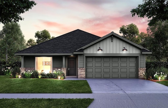 view of front facade with a yard and a garage