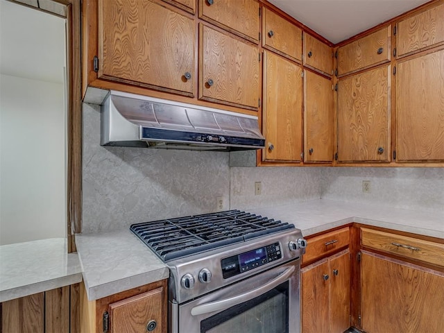 kitchen featuring backsplash and gas range