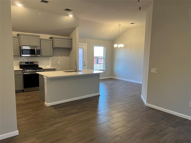 kitchen with visible vents, lofted ceiling, stainless steel appliances, gray cabinetry, and a sink