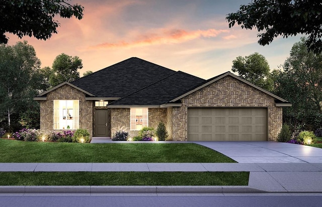 view of front of home with a garage and a yard