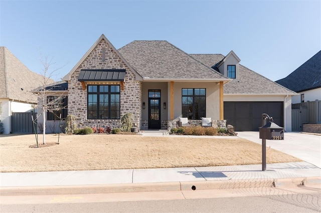 view of front facade featuring a garage and covered porch