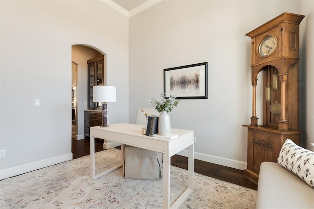 home office featuring hardwood / wood-style floors and crown molding