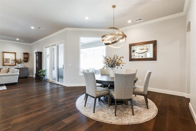 dining area featuring dark hardwood / wood-style floors, crown molding, and a notable chandelier