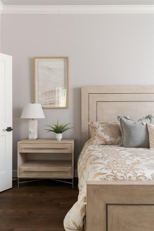 bedroom featuring dark hardwood / wood-style floors and ornamental molding