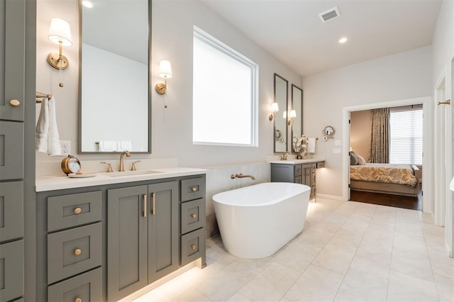 bathroom featuring vanity and a washtub