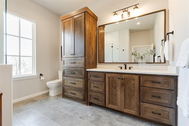 bathroom featuring toilet and vanity