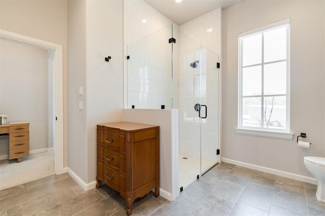 bathroom featuring toilet and an enclosed shower