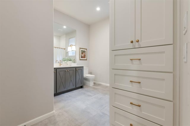 bathroom with toilet, vanity, and a shower with curtain