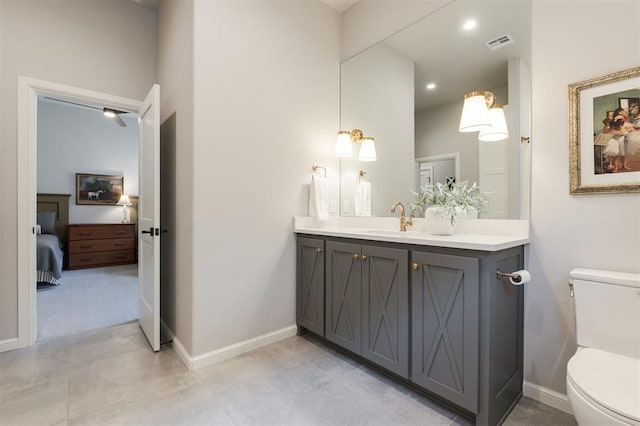 bathroom featuring toilet and vanity