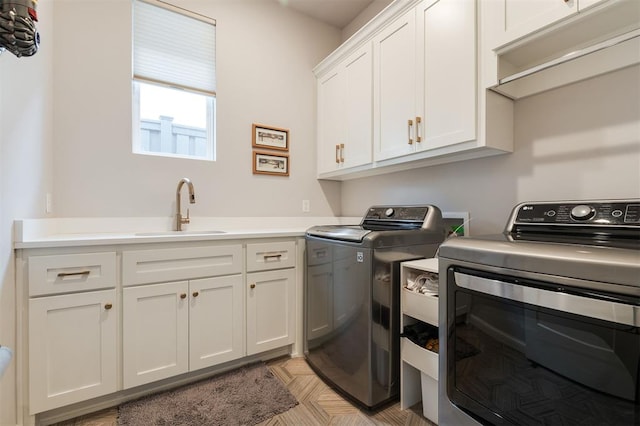 washroom with sink, separate washer and dryer, and cabinets