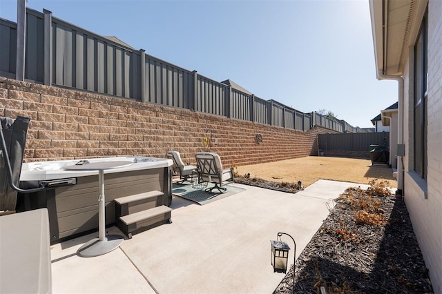 view of patio / terrace with a hot tub