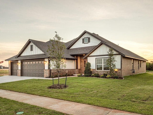 craftsman-style house featuring a garage and a lawn