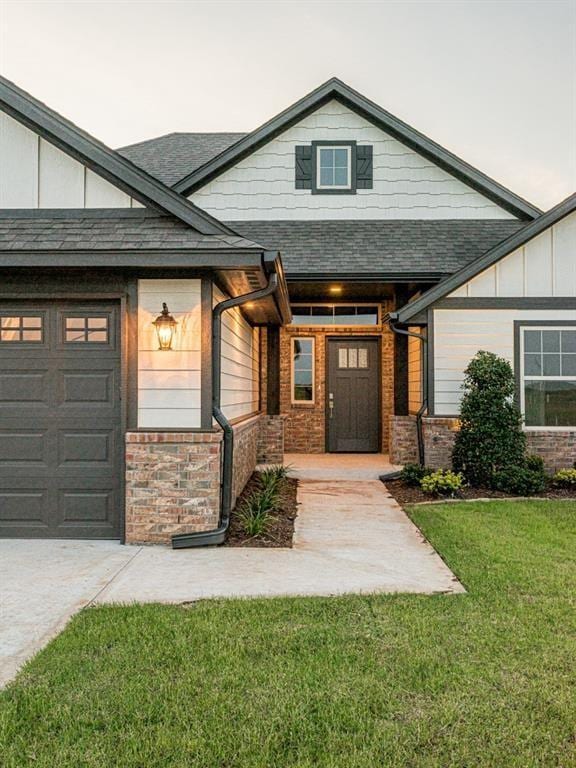 property entrance featuring a garage and a yard