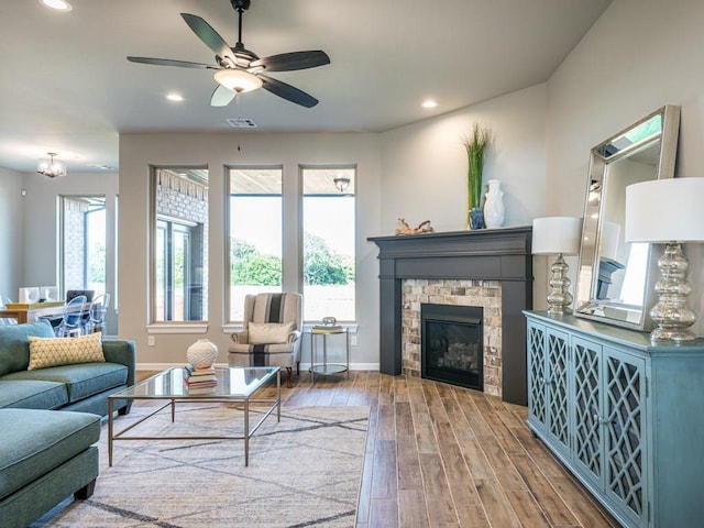 living room with ceiling fan, hardwood / wood-style floors, and a fireplace