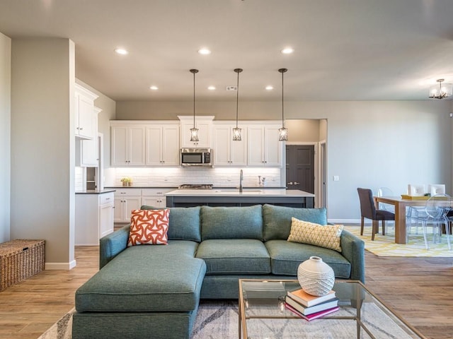 living room with sink and light hardwood / wood-style flooring