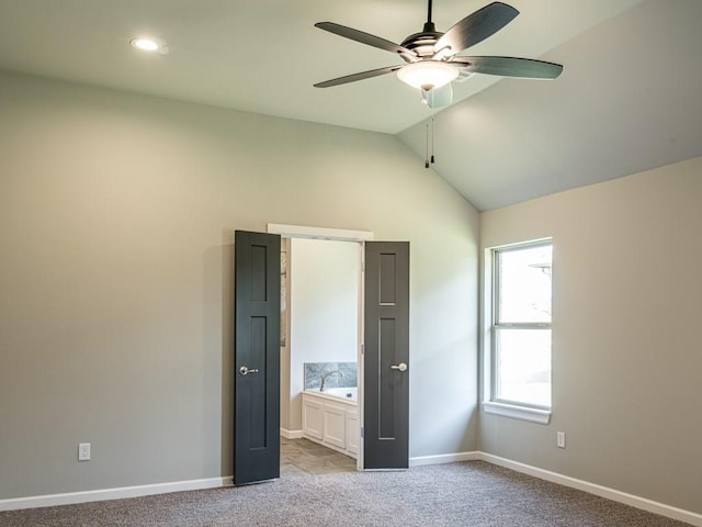 unfurnished bedroom featuring ceiling fan, light carpet, and lofted ceiling