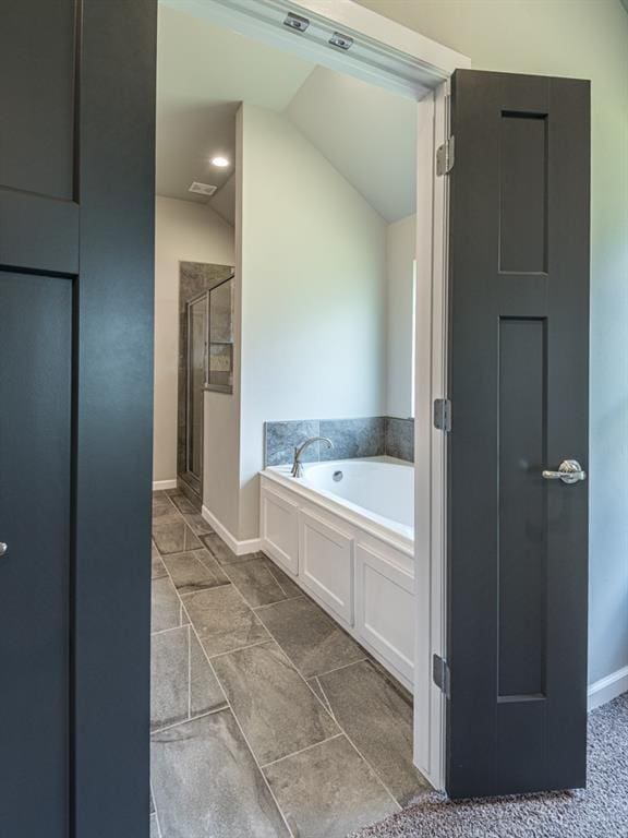 bathroom with vaulted ceiling and shower with separate bathtub