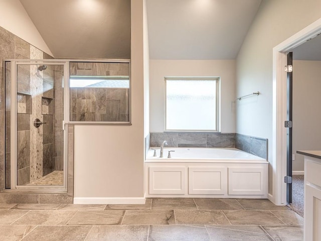 bathroom with separate shower and tub, lofted ceiling, and vanity