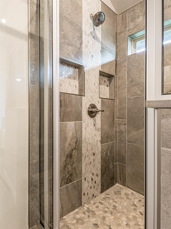 bathroom with tiled shower