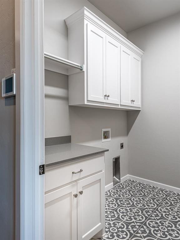 laundry area featuring washer hookup, electric dryer hookup, and cabinets