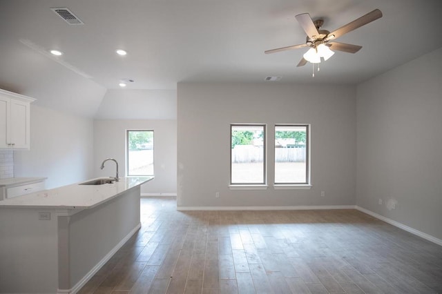 3120 Warwick Way, Moore, OK 73160 - kitchen with wood finished floors, white cabinets, open floor plan, ceiling fan, and recessed lighting