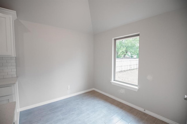 3120 Warwick Way, Moore, OK 73160 - spare room featuring baseboards and lofted ceiling
