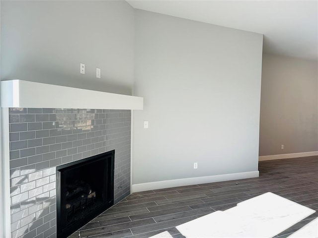 unfurnished living room featuring vaulted ceiling