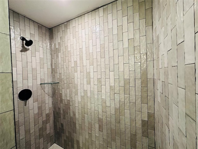 bathroom with a tile shower