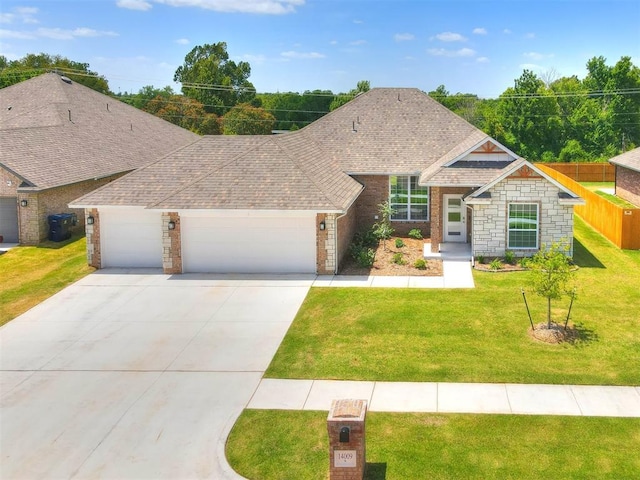 view of front of property with a garage and a front lawn