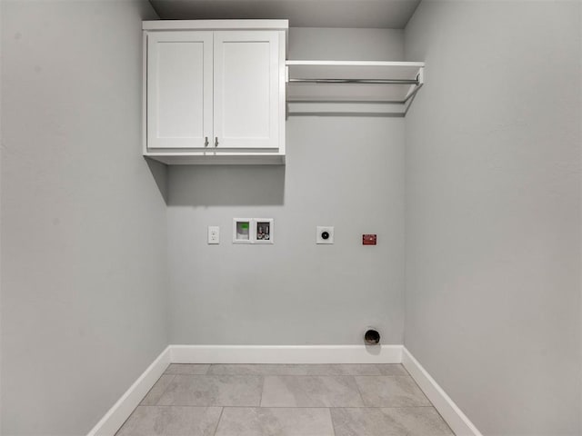 laundry area with cabinets, light tile patterned floors, hookup for a washing machine, and hookup for an electric dryer