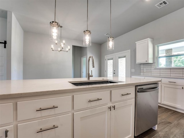 kitchen featuring a healthy amount of sunlight, decorative light fixtures, dishwasher, white cabinets, and sink