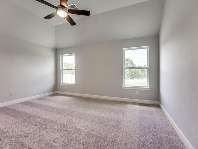 carpeted empty room featuring ceiling fan and vaulted ceiling