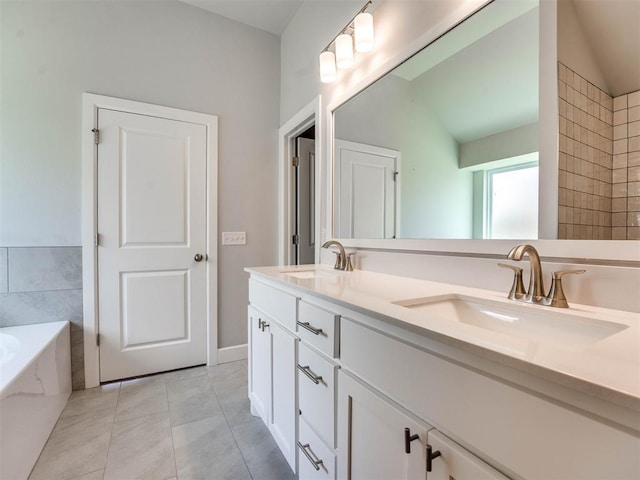 bathroom featuring lofted ceiling, vanity, a tub, and tile patterned floors