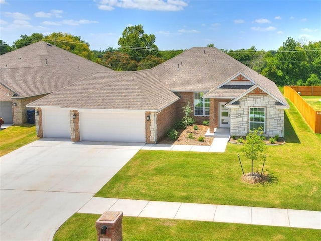 view of front of property featuring a front yard and a garage