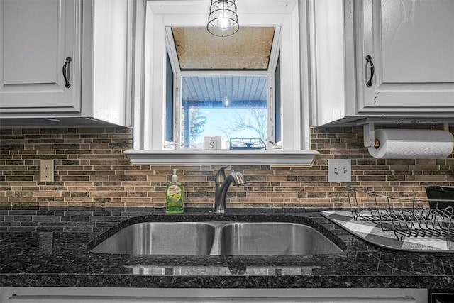 kitchen with sink, white cabinets, and decorative backsplash