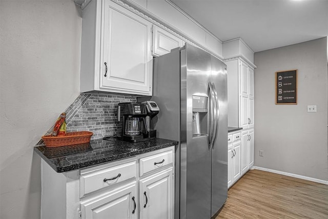 kitchen featuring decorative backsplash, white cabinetry, stainless steel fridge, and light wood-type flooring