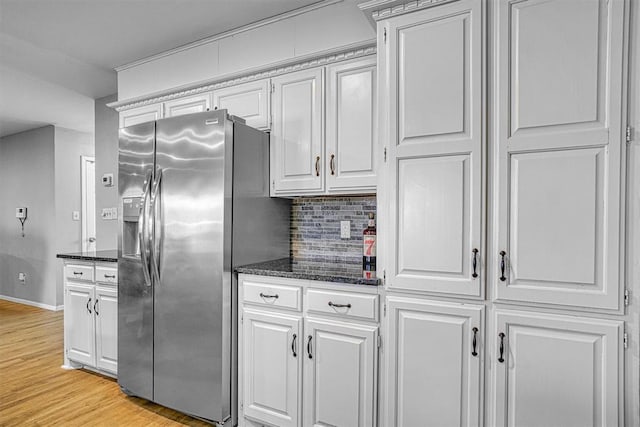 kitchen featuring backsplash, white cabinetry, stainless steel fridge, and light wood-type flooring