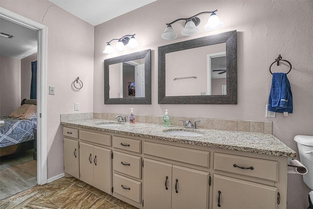 bathroom with toilet and vanity