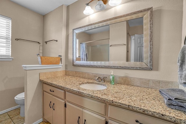 bathroom with vanity, toilet, curtained shower, and tile patterned flooring