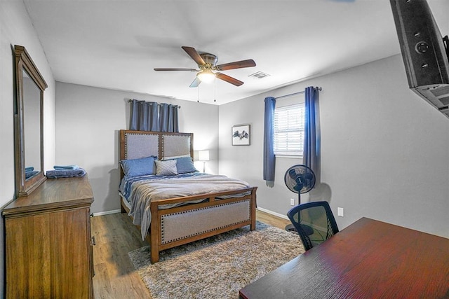 bedroom featuring ceiling fan and dark hardwood / wood-style flooring