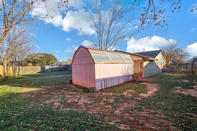 exterior space featuring a lawn and an outbuilding