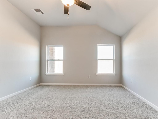 carpeted spare room with ceiling fan and lofted ceiling