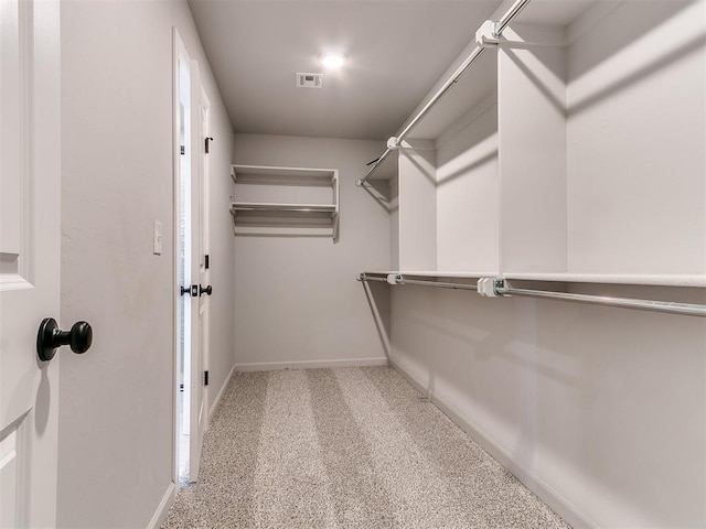 walk in closet with carpet